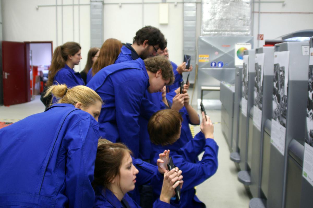 Die Teilnehmer erkunden die AR an der Druckmaschine